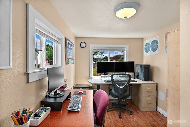 a view of a workspace with furniture and a window