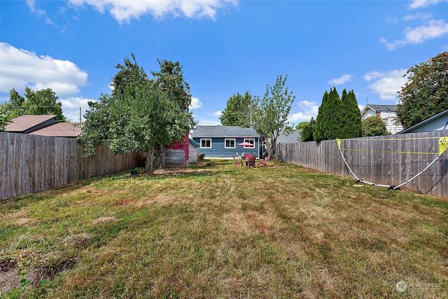 a view of a backyard with a garden and deck