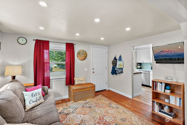 a living room with furniture and a book shelf