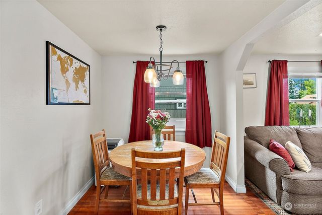 a view of a dining room with furniture wooden floor and a chandelier