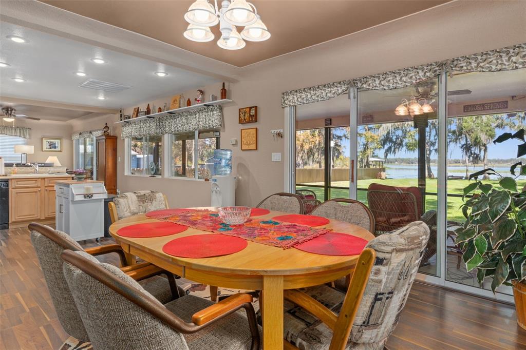 6185 West Riverbend Road Dunnellon, FL 34433 - Photo 18 of 49 a view of a dining room with furniture window and wooden floor