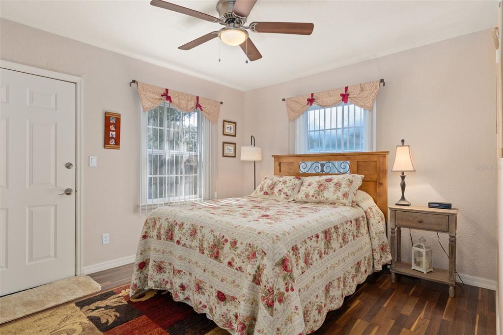 6185 West Riverbend Road Dunnellon, FL 34433 - Photo 23 of 49 a bedroom with a bed and wooden floor