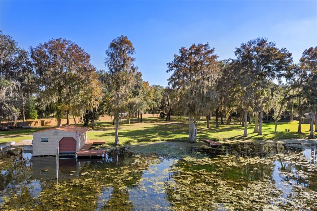 6185 West Riverbend Road Dunnellon, FL 34433 - Photo 48 of 49 a view of a lake with a house in the background