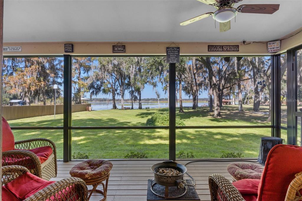 6185 West Riverbend Road Dunnellon, FL 34433 - Photo 8 of 49 a living room with furniture and a floor to ceiling window