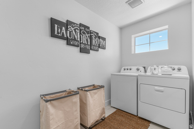 1418 West 2350th South, Unit 15 Perry, UT 84302 - Photo 18 of 22 Dedicated laundry space featuring a window, overhead ventilation, and light-toned wall paint