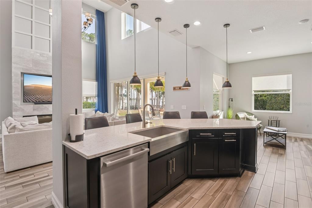1440 Keystone Ridge Circle Tarpon Springs, FL 34688 - Photo 12 of 45 a kitchen with a sink stove and wooden floor