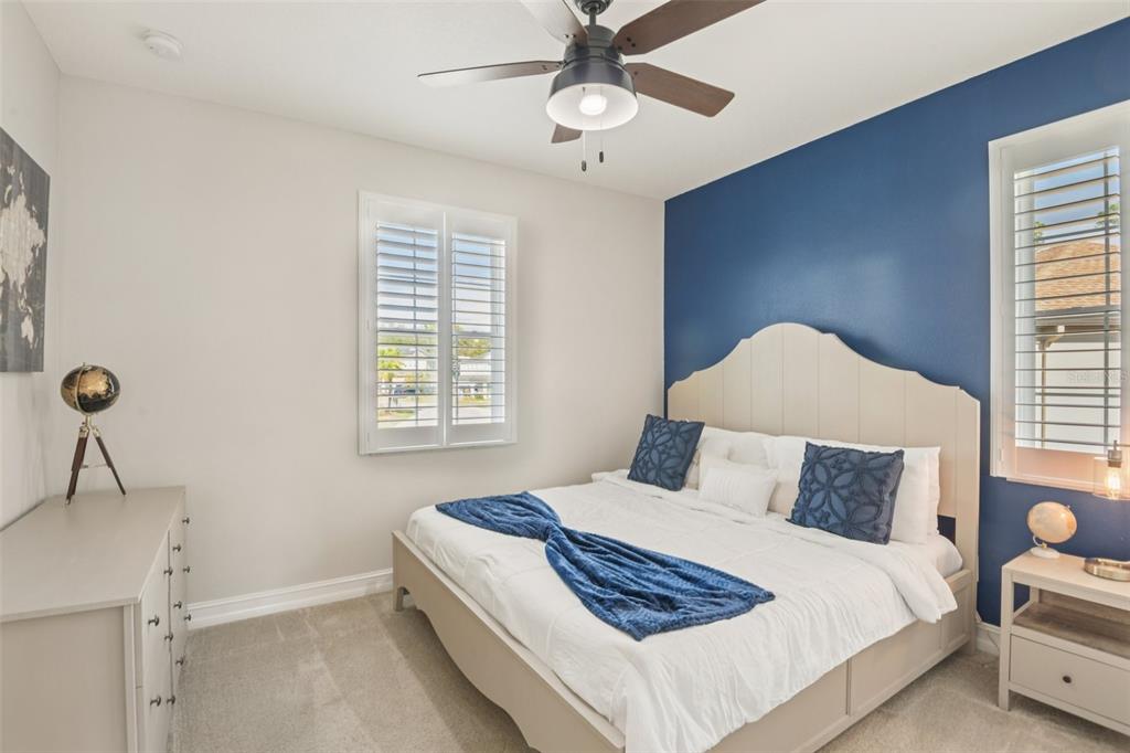 1440 Keystone Ridge Circle Tarpon Springs, FL 34688 - Photo 22 of 45 a bedroom with a bed and a window