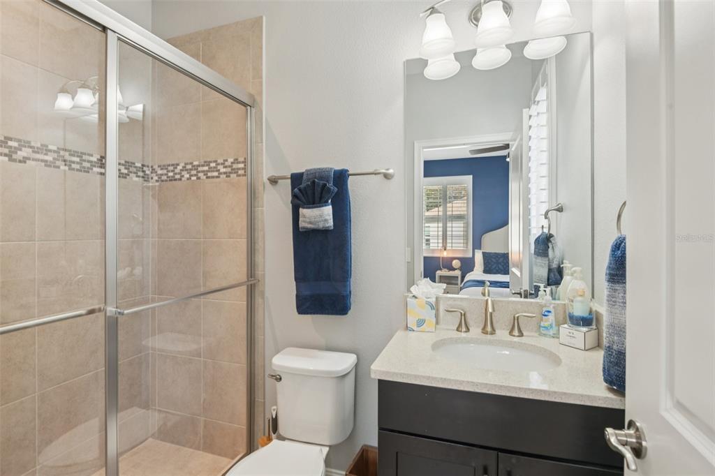 1440 Keystone Ridge Circle Tarpon Springs, FL 34688 - Photo 24 of 45 a bathroom with a sink toilet a mirror and shower