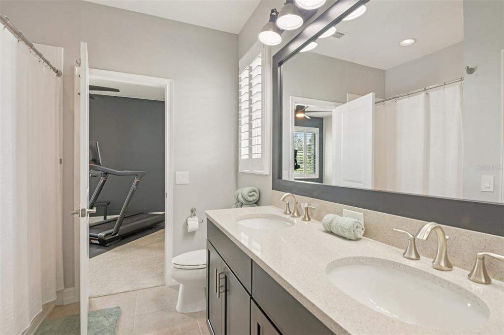 1440 Keystone Ridge Circle Tarpon Springs, FL 34688 - Photo 27 of 45 a bathroom with a double vanity sink and a mirror