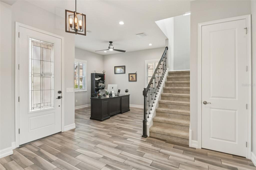 1440 Keystone Ridge Circle Tarpon Springs, FL 34688 - Photo 4 of 45 a view of a room with wooden floor and stairs