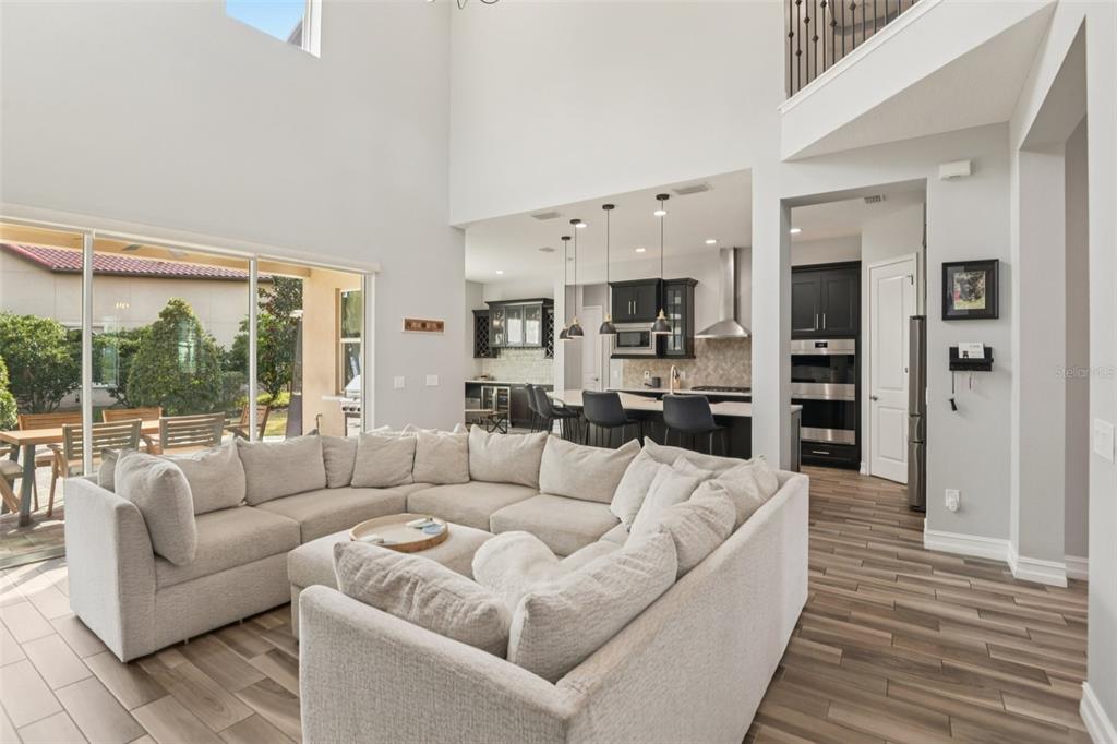 1440 Keystone Ridge Circle Tarpon Springs, FL 34688 - Photo 6 of 45 a living room with furniture and a large window