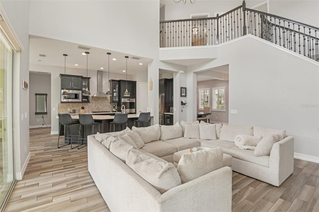 1440 Keystone Ridge Circle Tarpon Springs, FL 34688 - Photo 7 of 45 a living room with furniture and kitchen view