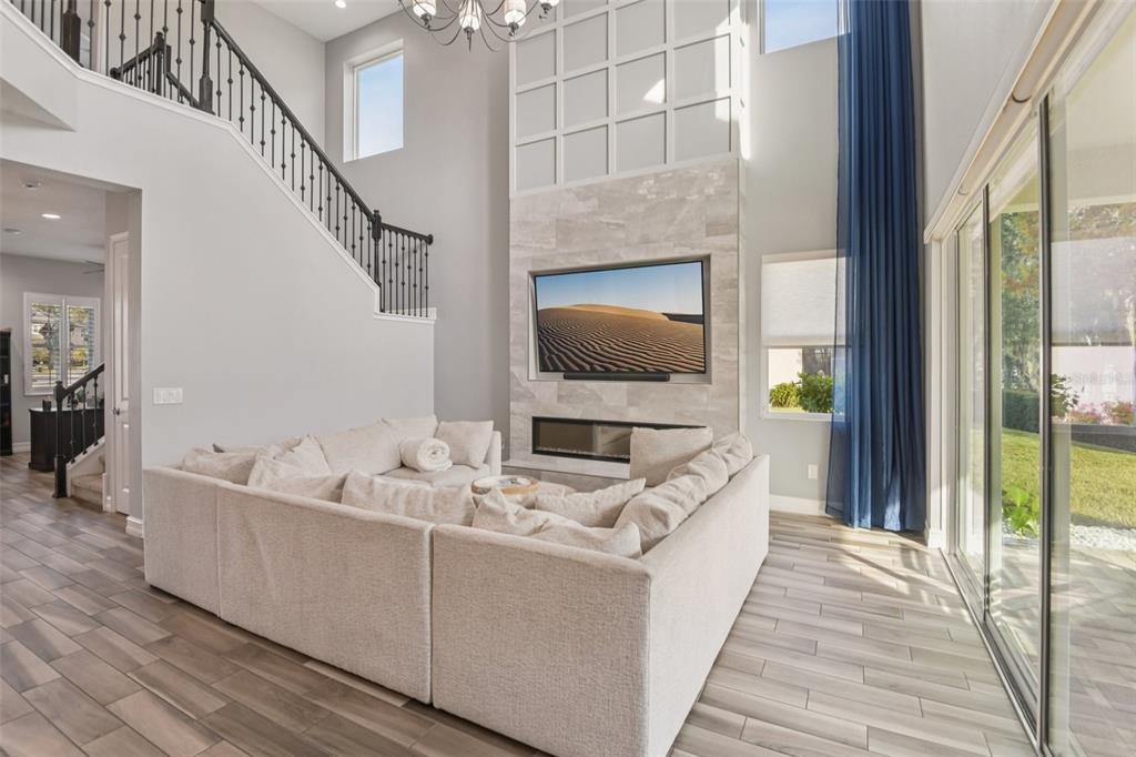 1440 Keystone Ridge Circle Tarpon Springs, FL 34688 - Photo 8 of 45 a living room with furniture and a flat screen tv