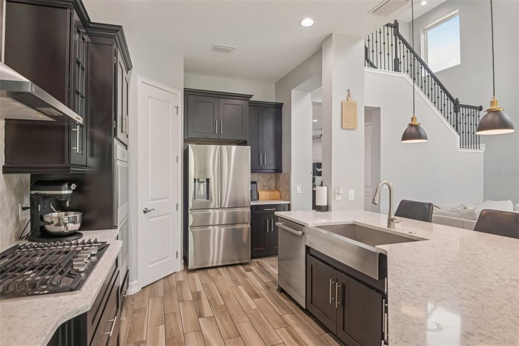1440 Keystone Ridge Circle Tarpon Springs, FL 34688 - Photo 10 of 45 a kitchen with granite countertop a sink stove and refrigerator