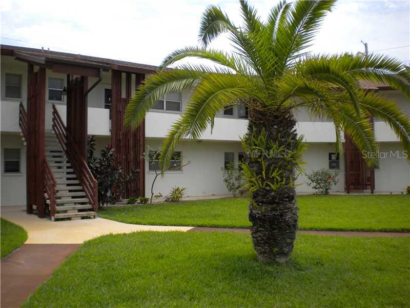 245 Center Road, Unit 208 Venice, FL 34285 - Photo 1 of 1 a front view of house with yard and green space