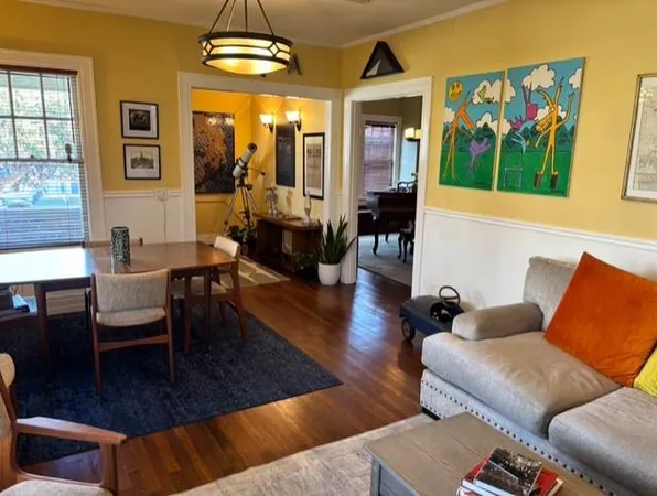 a living room with furniture and a chandelier