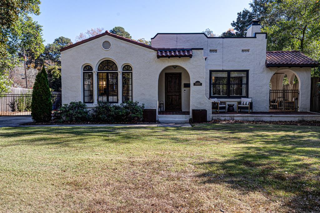 a view of house with garden and swimming pool