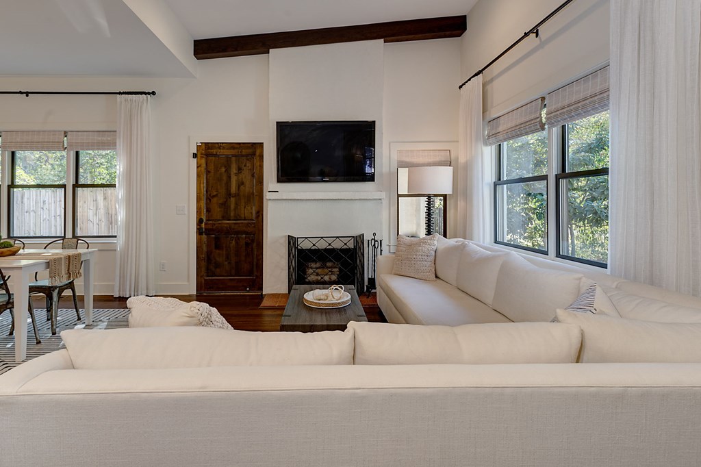 1400 17th Avenue Columbus, GA 31901 - Photo 15 of 50 a living room with furniture a flat screen tv and a fireplace