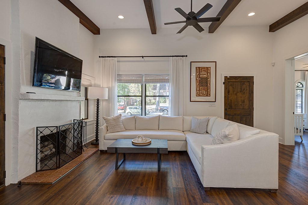 1400 17th Avenue Columbus, GA 31901 - Photo 17 of 50 a living room with furniture a flat screen tv and a fireplace