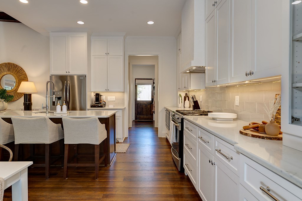 1400 17th Avenue Columbus, GA 31901 - Photo 25 of 50 a kitchen with a table chairs stove and cabinets