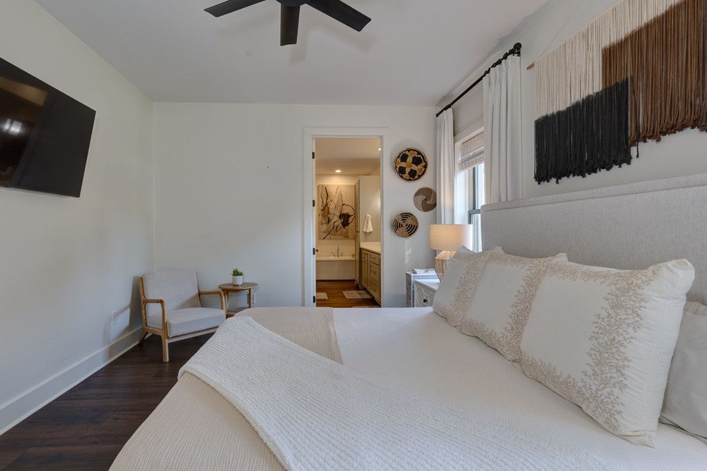 1400 17th Avenue Columbus, GA 31901 - Photo 27 of 50 a bedroom with a bed a tv and wooden floor