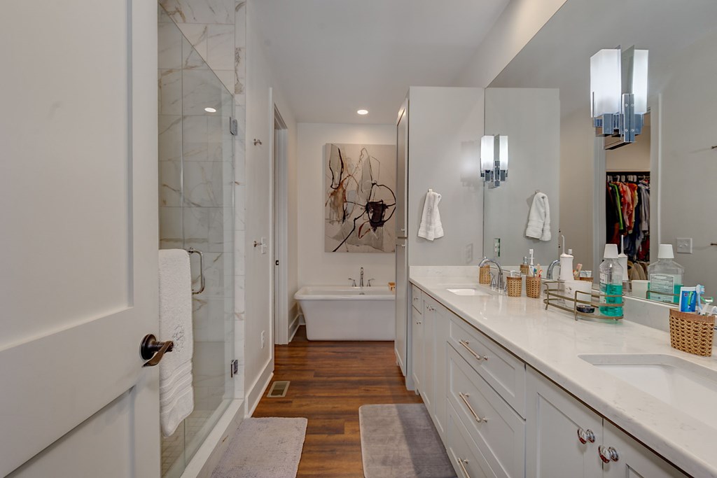 1400 17th Avenue Columbus, GA 31901 - Photo 29 of 50 a bathroom with a double vanity sink a large mirror a shower and a bathtub