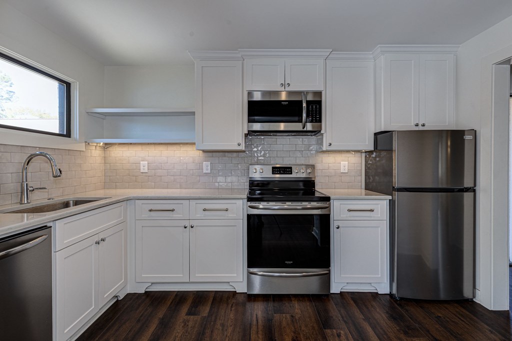 1400 17th Avenue Columbus, GA 31901 - Photo 42 of 50 a kitchen with white cabinets stainless steel appliances and sink