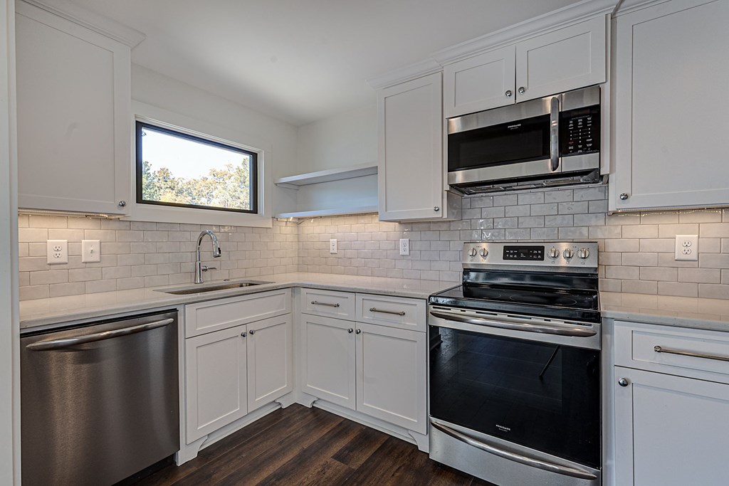 1400 17th Avenue Columbus, GA 31901 - Photo 43 of 50 a kitchen with stainless steel appliances a stove microwave and sink