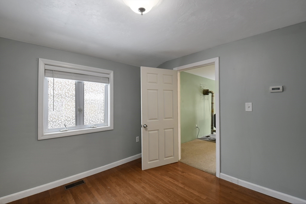 15 Myrtle Avenue Sterling, MA 01564 - Photo 13 of 33 an empty room with wooden floor and a window