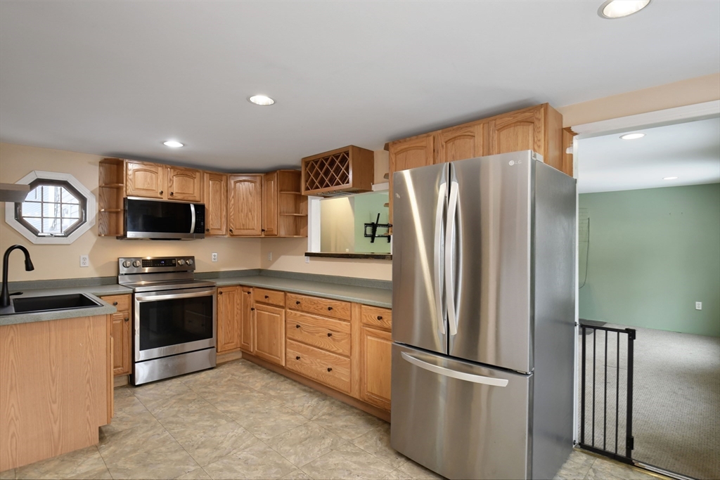 15 Myrtle Avenue Sterling, MA 01564 - Photo 15 of 33 a kitchen with stainless steel appliances granite countertop a refrigerator stove and microwave