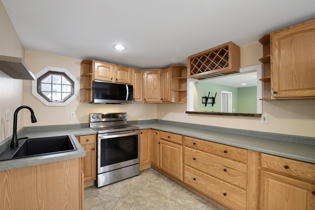 15 Myrtle Avenue Sterling, MA 01564 - Photo 16 of 33 a kitchen with granite countertop stainless steel appliances a sink cabinets and a window