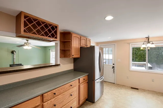 a kitchen with stainless steel appliances granite countertop a refrigerator and a sink