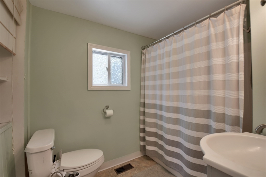 15 Myrtle Avenue Sterling, MA 01564 - Photo 19 of 33 a white toilet sitting next to a shower curtain