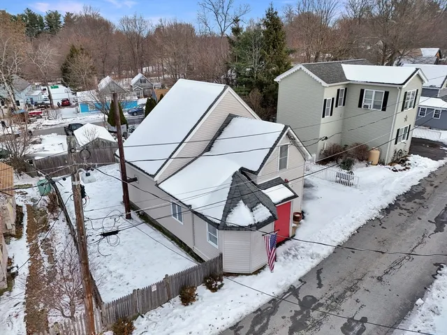a view of a house with pool and sitting area