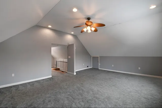 a view of a room with gym equipment and a chandelier