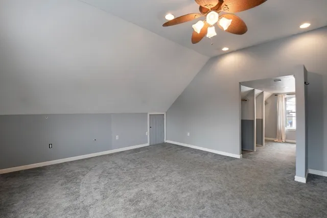 en empty room with windows and fan