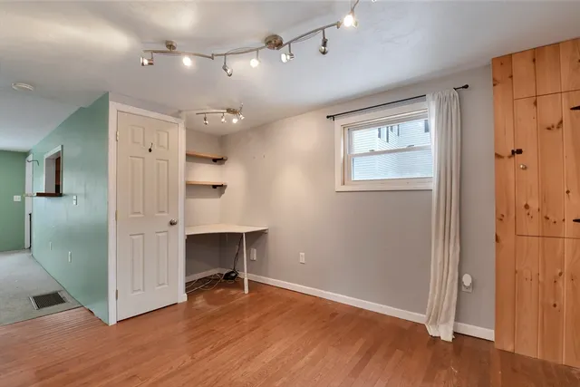 wooden floor in an empty room with a window