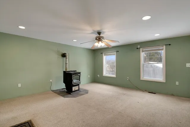a view of a livingroom with a ceiling fan and window