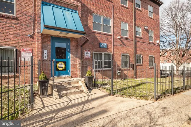 a view of a brick building with many windows