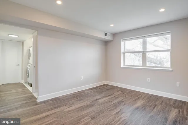 a view of a room with wooden floor and windows
