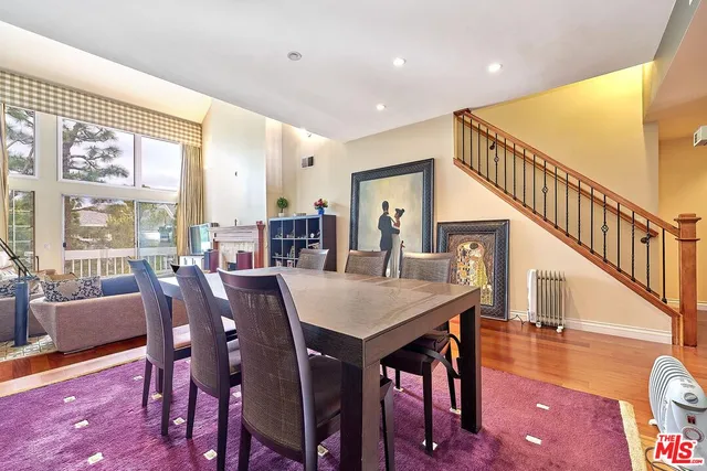 a living room with furniture a fireplace and a large window