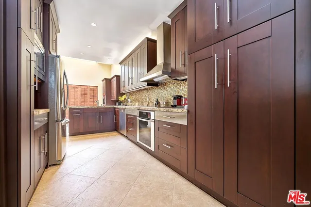a kitchen with stainless steel appliances granite countertop a stove and cabinets