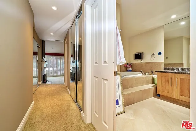 a view of a swimming pool with a patio and plants