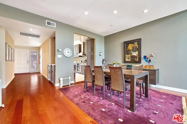 a dining room with furniture window and wooden floor