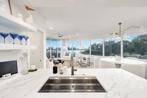 a kitchen with stainless steel appliances kitchen island granite countertop a sink and cabinets