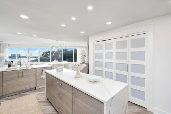a kitchen with kitchen island cabinets and refrigerator