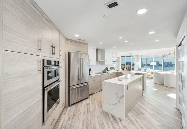 a living room with stainless steel appliances kitchen island granite countertop furniture and a kitchen view