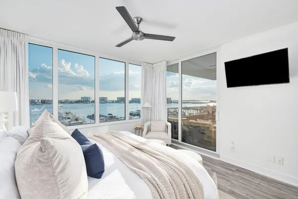 a bedroom with a large bed and a large window