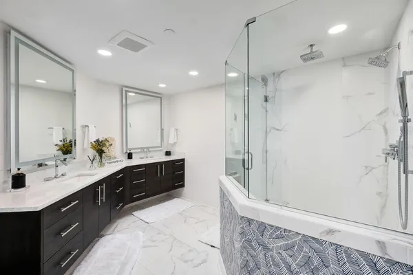 a bathroom with a sink a mirror and a shower