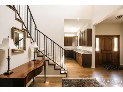 a view of entryway and hall with wooden floor